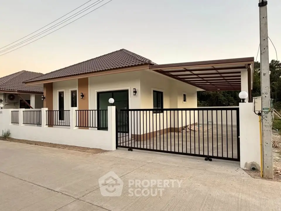 Modern single-story house with gated driveway and tiled roof