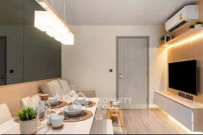 Modern living room with stylish decor, cozy seating, and elegant dining setup in a contemporary apartment.