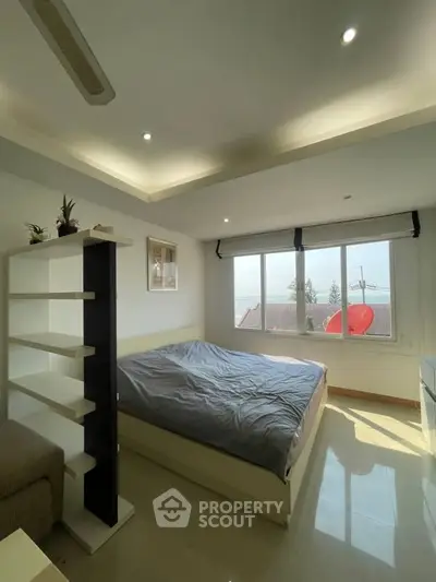 Bright bedroom with large windows and modern decor