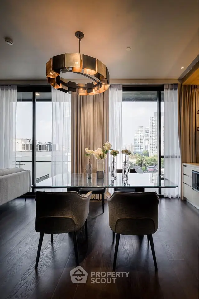 Luxurious modern dining area with city view, elegant chandelier, and floor-to-ceiling windows.