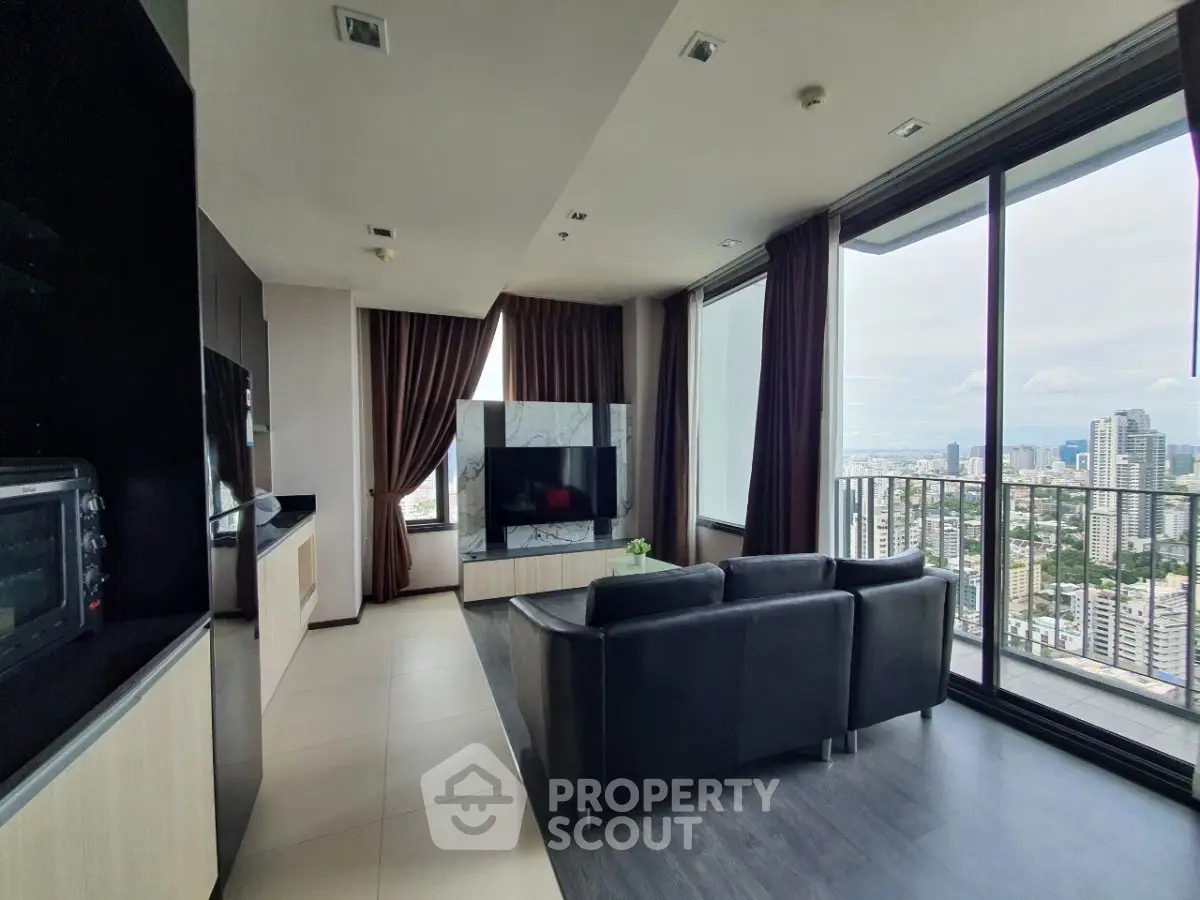 Luxurious high-rise living room with stunning city view and modern furnishings.