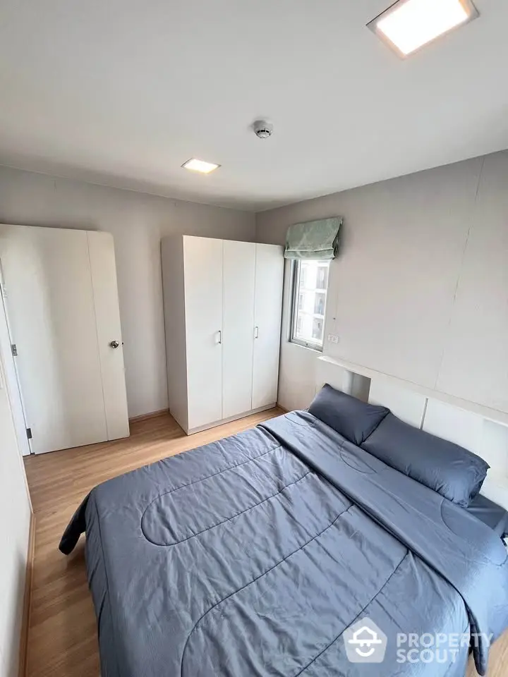 Cozy bedroom with modern decor and ample natural light