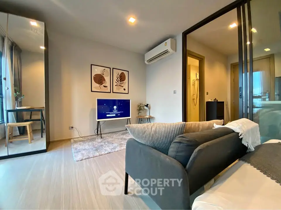 Modern living room with stylish decor and large mirror
