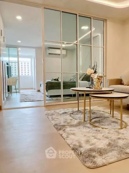Modern living room with elegant decor and mirrored sliding doors in a stylish apartment.