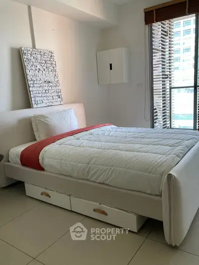 Cozy bedroom with modern decor and natural light from large window