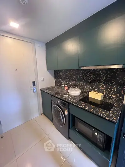 Modern kitchen with sleek cabinetry and built-in appliances