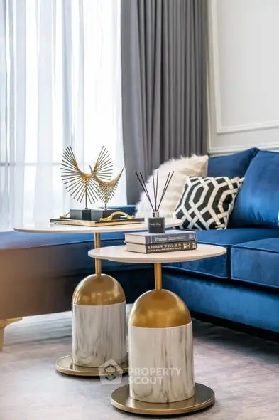 Elegant living room with blue velvet sofa and stylish decor