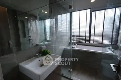 Modern bathroom with glass shower and large window
