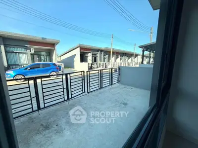 Modern residential building with spacious balcony and street view