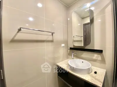 Modern bathroom with sleek design featuring a stylish sink and mirror