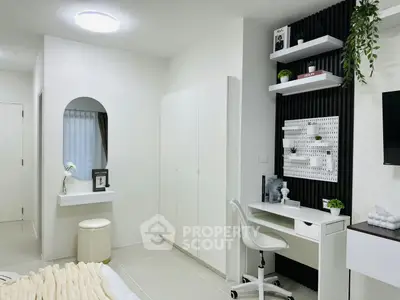 Modern bedroom with sleek white furniture and stylish workspace