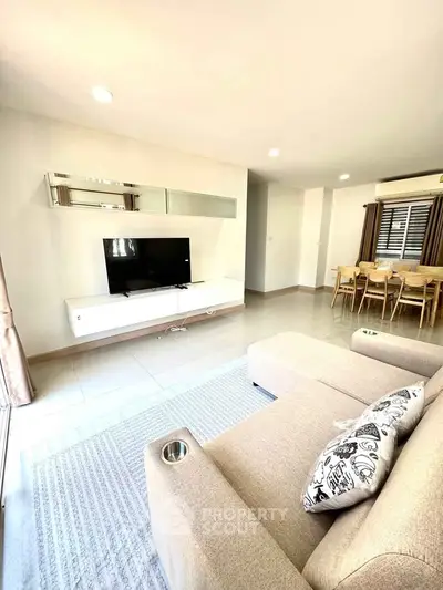 Spacious modern living room with cozy seating and dining area, perfect for relaxation and entertainment.