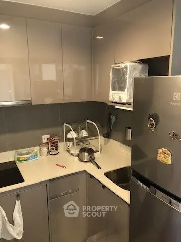 Modern compact kitchen with sleek cabinets and stainless steel appliances