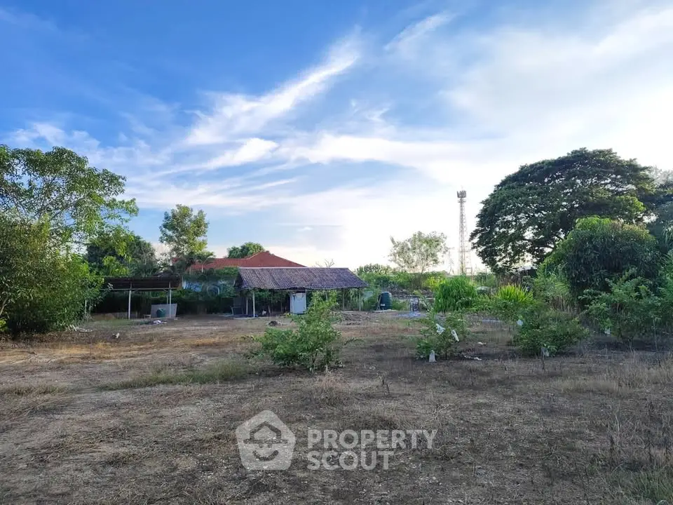 Expansive rural property with lush greenery and open skies, perfect for development or agriculture.