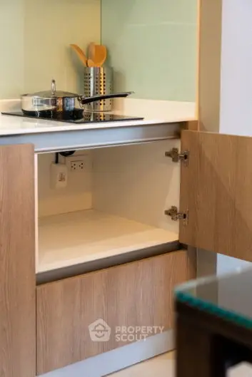 Modern kitchen with open cabinet and sleek stovetop