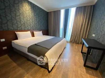 Modern bedroom with stylish wallpaper and large windows