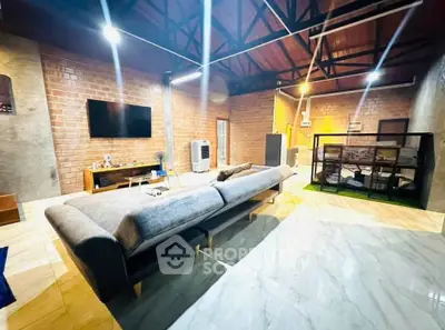 Spacious modern living room with stylish furniture and exposed brick walls