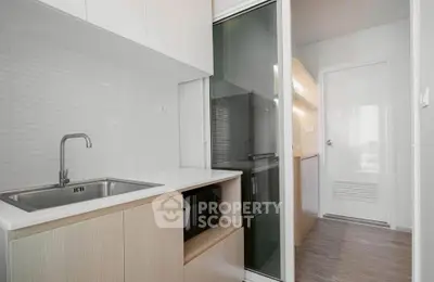 Modern kitchen with sleek cabinetry and built-in appliances in a compact layout.