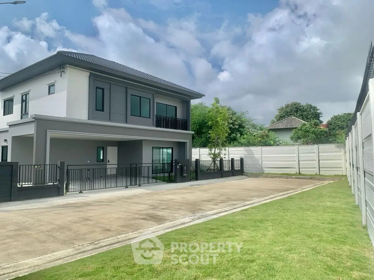 Modern two-story house with spacious driveway and lush green lawn