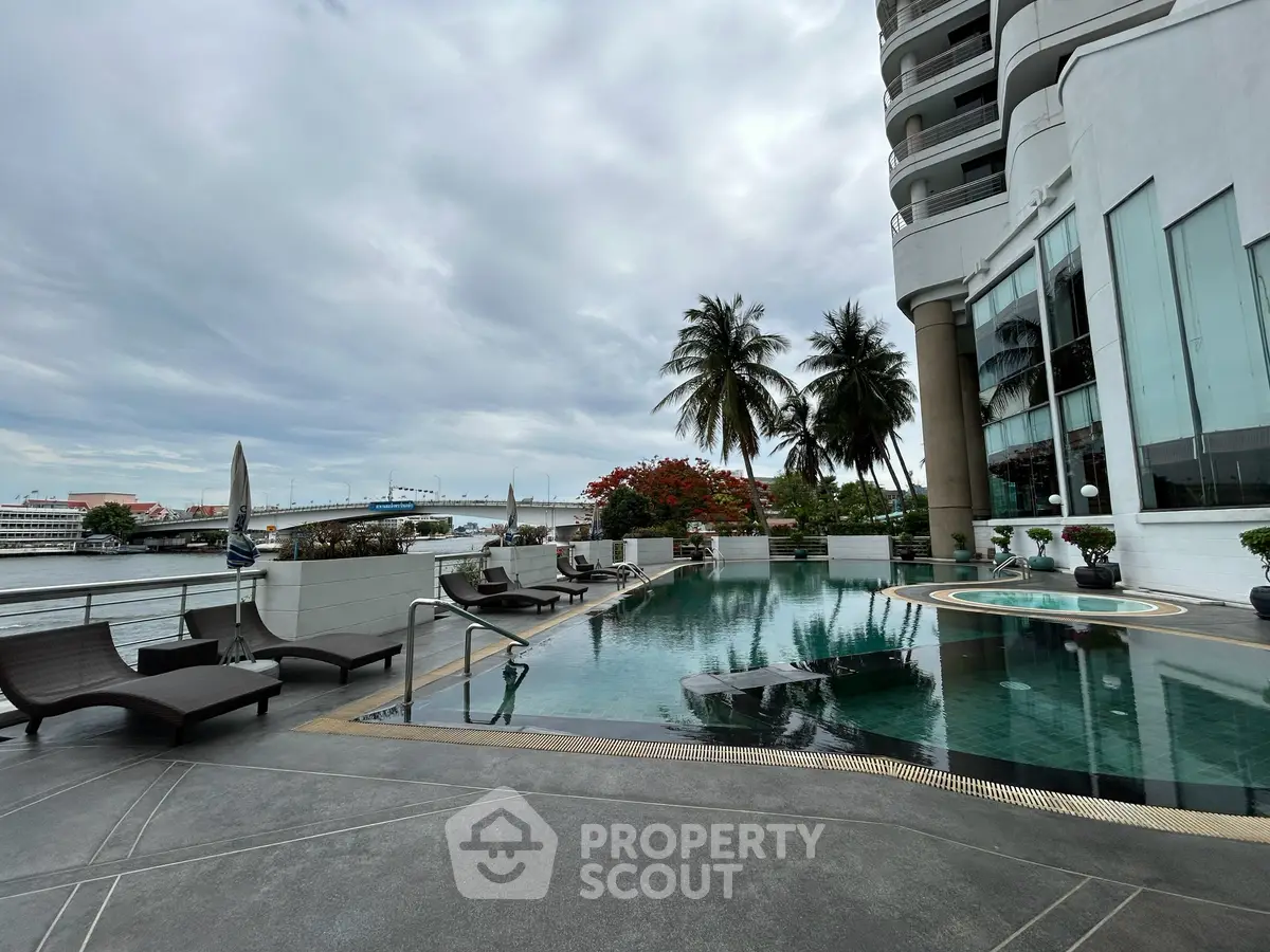 Luxurious riverside pool area with modern loungers and stunning views, perfect for relaxation and leisure.
