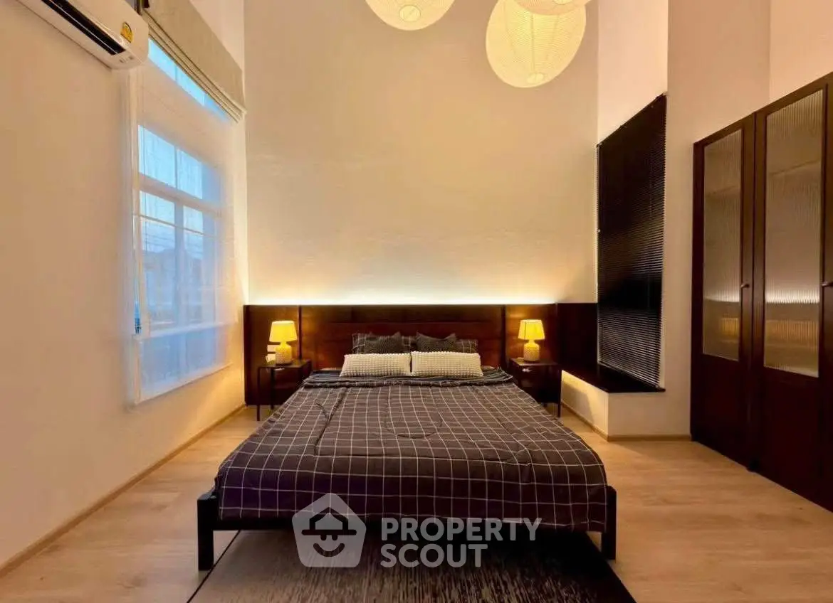 Spacious bedroom with modern decor and ambient lighting