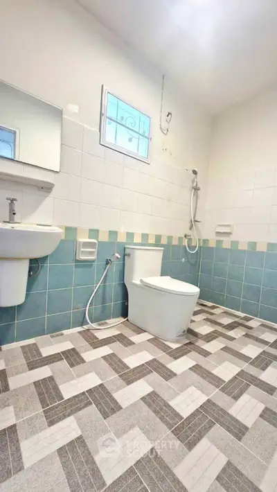 Spacious bathroom with modern fixtures and stylish tile flooring