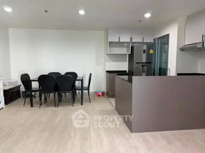 Modern open-plan kitchen and dining area with sleek design and ample space.