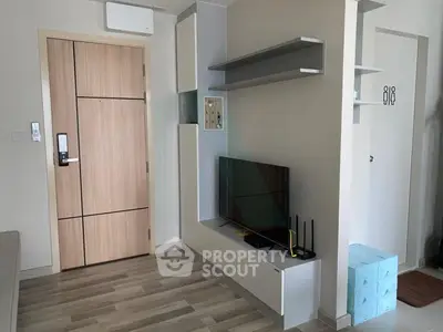 Modern living room with sleek TV unit and wooden flooring