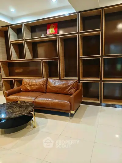 Modern living room with leather sofa and stylish shelving unit