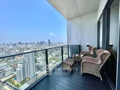 Luxurious high-rise balcony with stunning city skyline view and elegant wicker furniture.