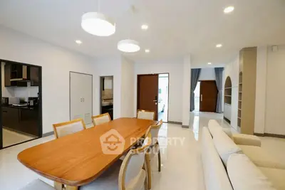 Spacious modern living room with elegant dining area and open kitchen layout