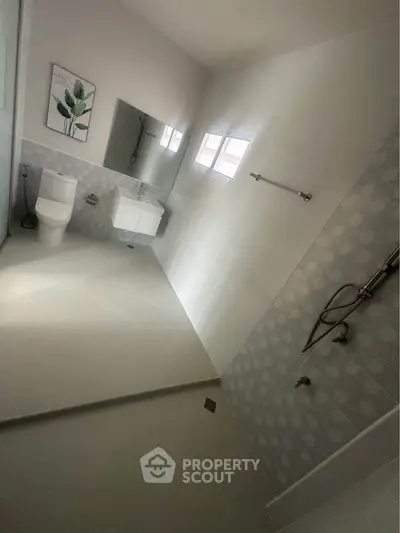 Modern bathroom with sleek fixtures and spacious shower area