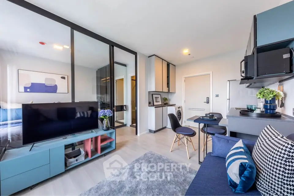 Modern open-plan living room with stylish decor and glass partition