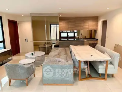 Modern living room with stylish furniture and open kitchen layout in a contemporary apartment.
