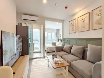 Modern living room with cozy sofa and balcony view in stylish apartment.