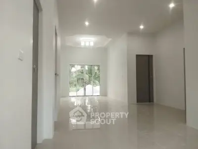 Spacious modern living room with large windows and glossy tile flooring