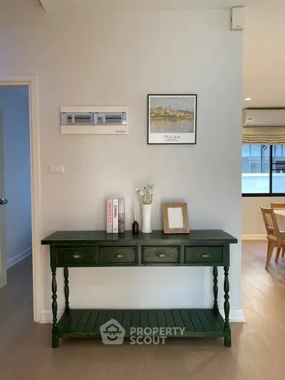 Charming interior with elegant green console table and tasteful decor in a cozy living space.