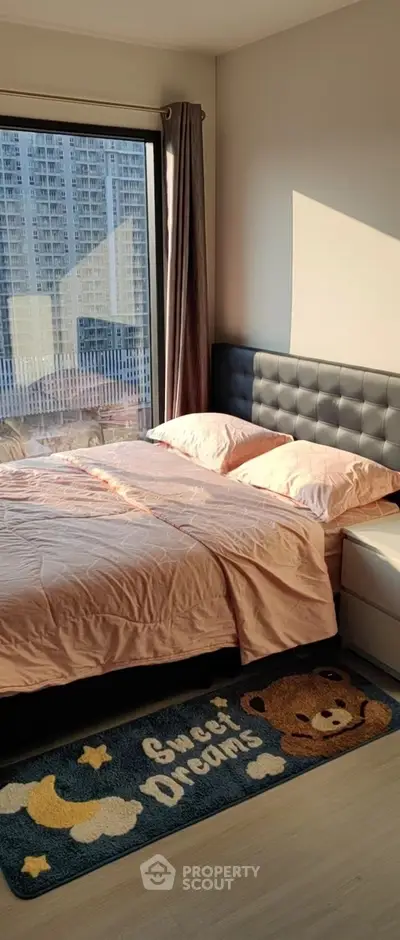 Cozy bedroom with large window and stylish decor in modern apartment