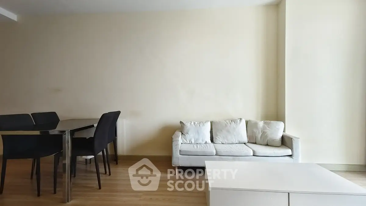 Spacious living room with modern furniture and elegant dining area, perfect for relaxation and entertaining.