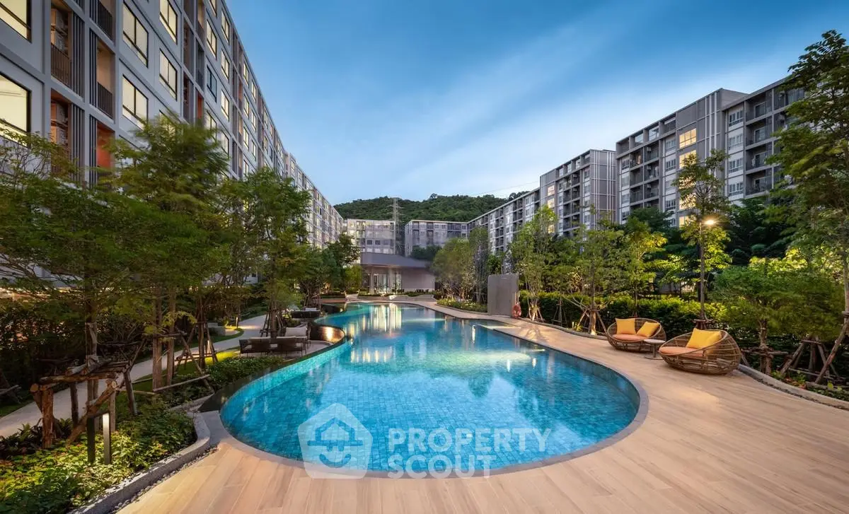 Luxurious residential complex with stunning pool and lush greenery, perfect for relaxation and leisure.