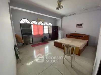 Spacious bedroom with large windows and minimalist decor