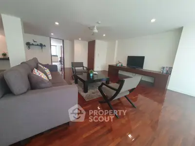 Spacious living room with modern furniture and polished wooden floors
