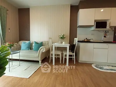 Charming open-layout living room with cozy seating and modern kitchen area, perfect for urban living.