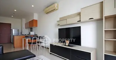 Modern living room with open kitchen and stylish furniture in a contemporary apartment.