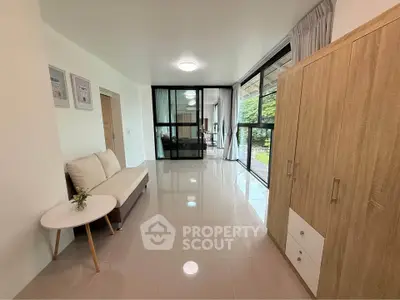 Spacious modern living room with large windows and stylish furniture