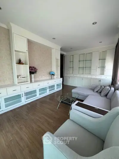 Spacious living room with elegant built-in cabinets and cozy seating area.