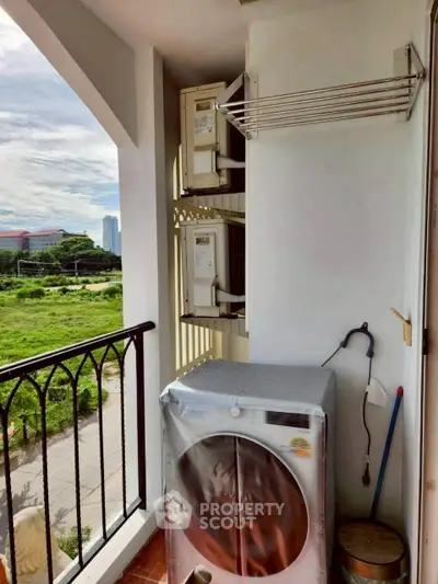 Charming balcony with laundry area and scenic view, perfect for urban living convenience.