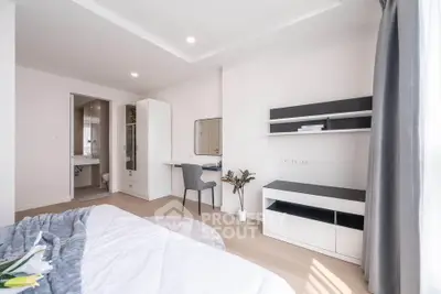 Spacious modern bedroom with study area and natural light