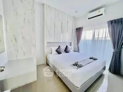 Modern bedroom with elegant decor and natural light, featuring a comfortable bed and stylish curtains.