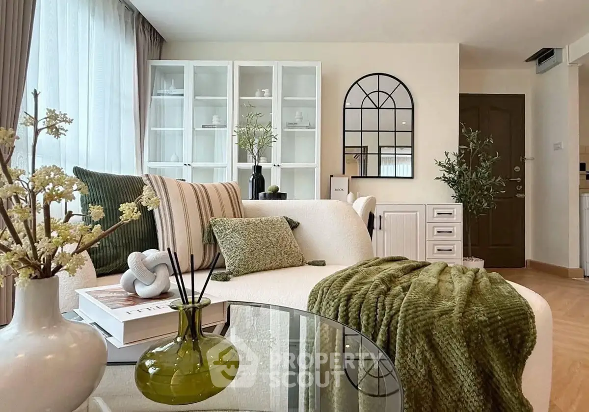 Stylish living room with modern decor and cozy green accents, perfect for relaxation and entertaining.
